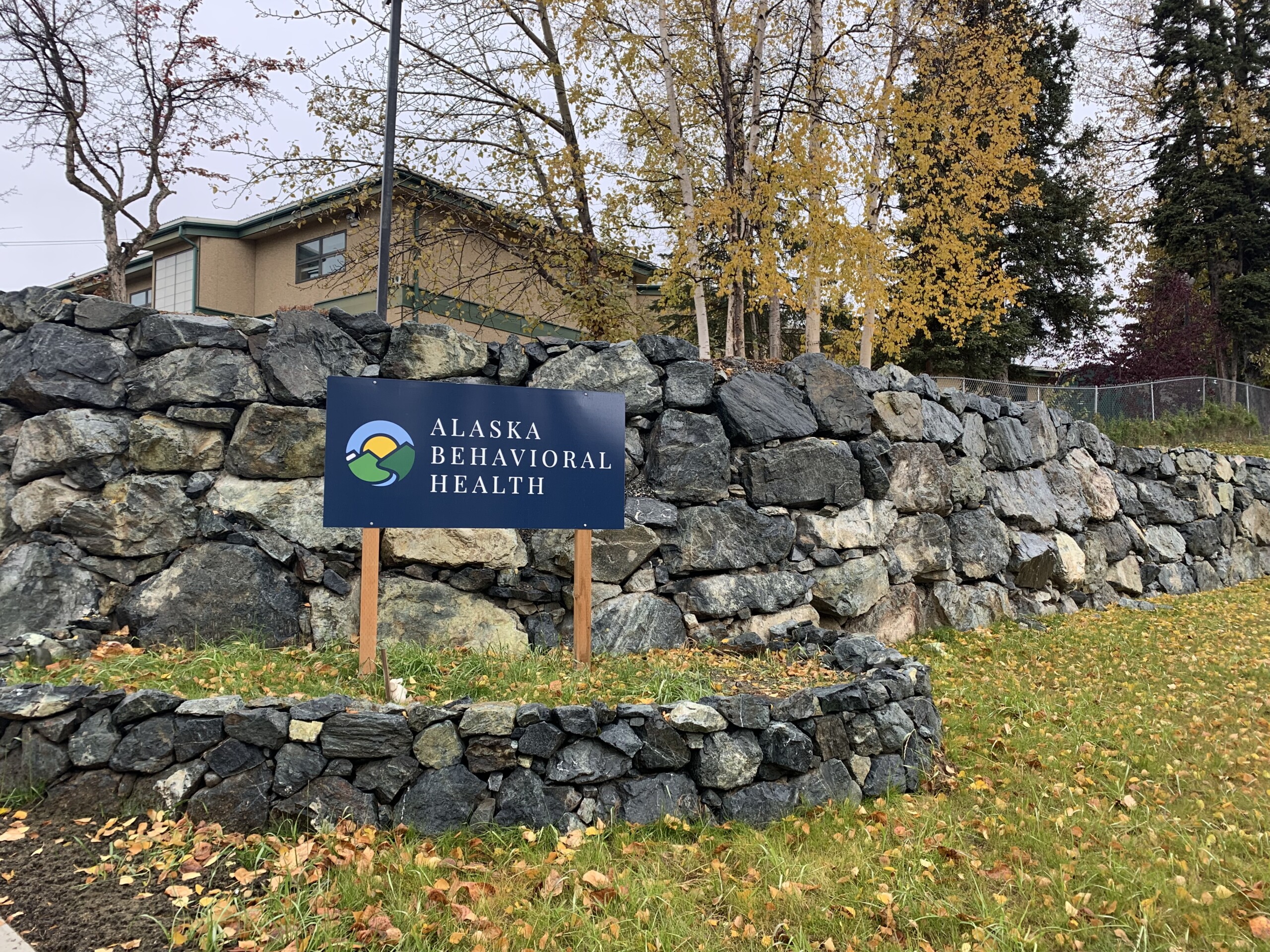 fall scene of retaining wall and sign that says Alaska Behavioral Health